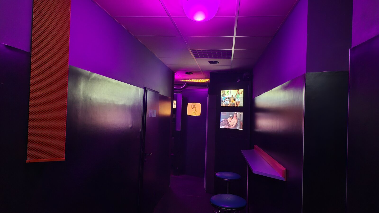 View of the corridor with video screens and seating