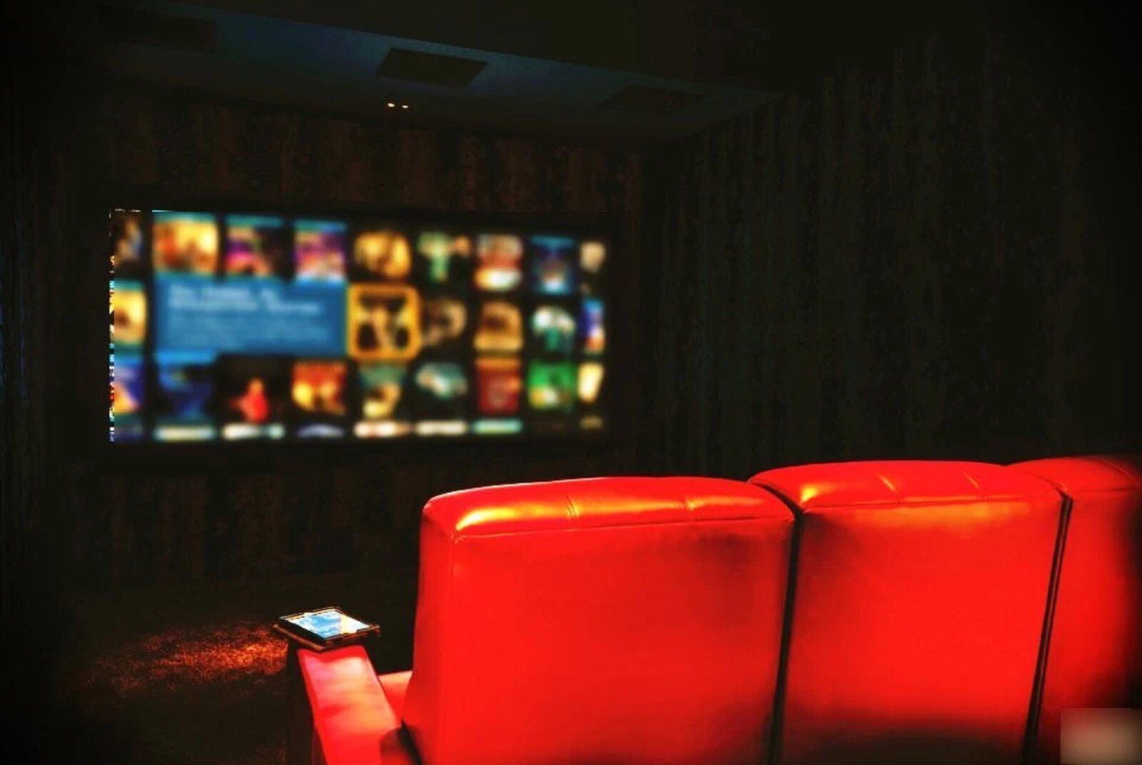 Cinema room with red leather tiered seating