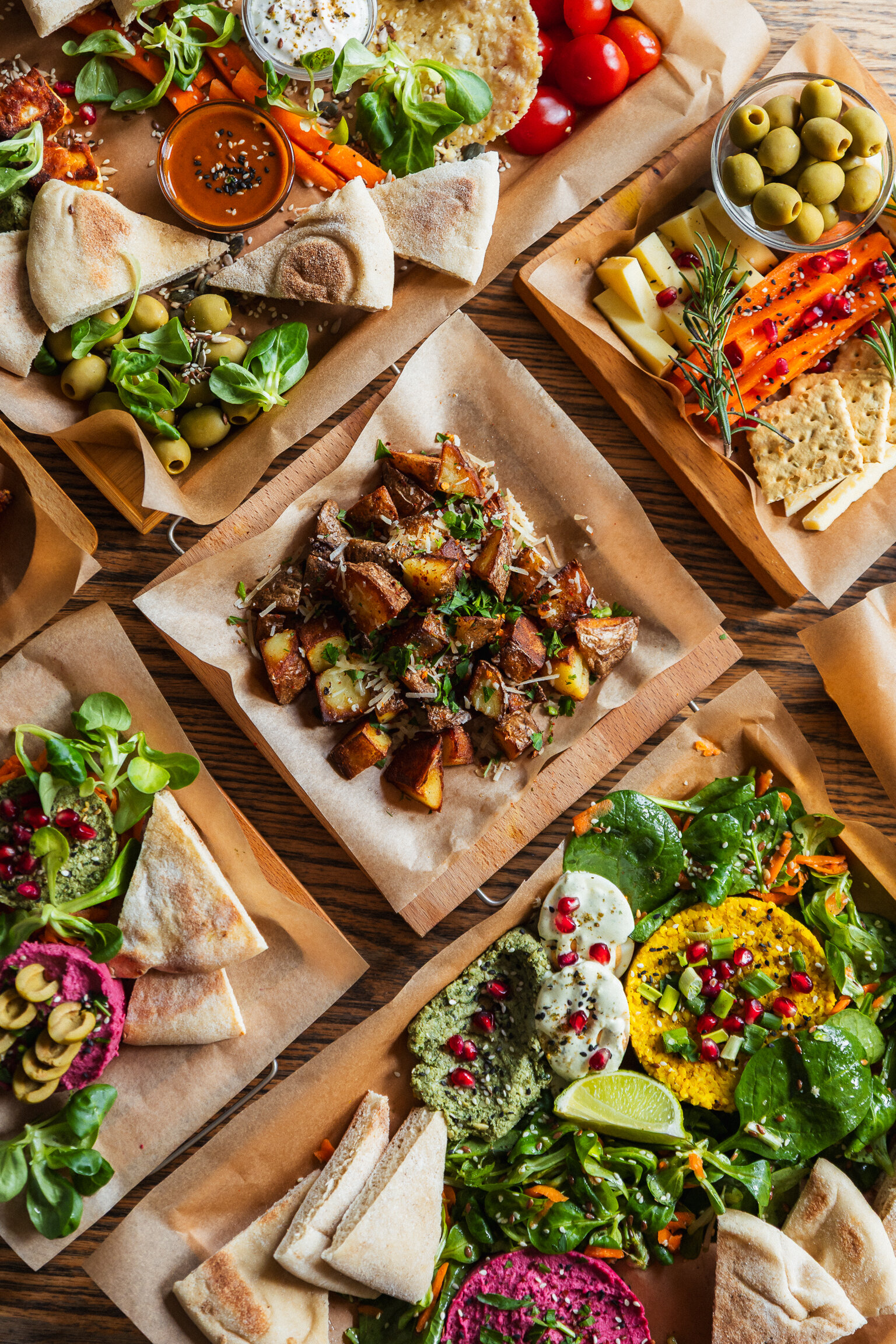 A vegetarian sharing platter with pita, hummus, roasted vegetables and dips.