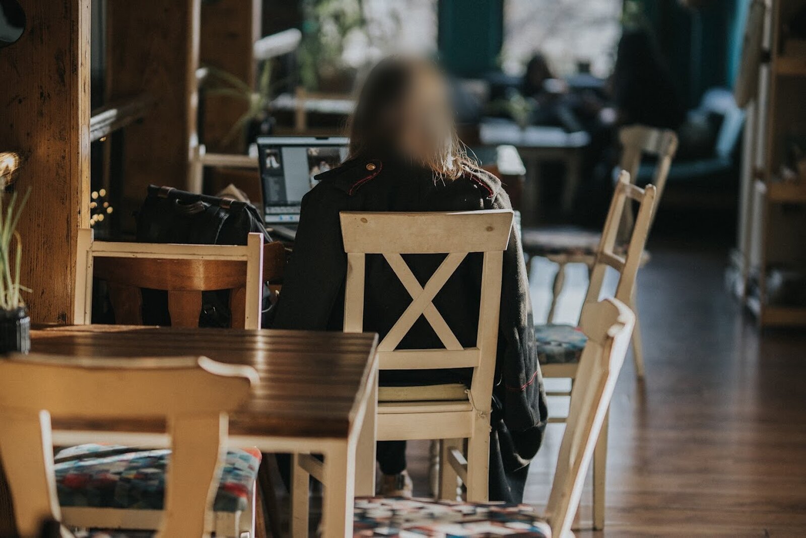 A guest working from a laptop at one of the café tables.