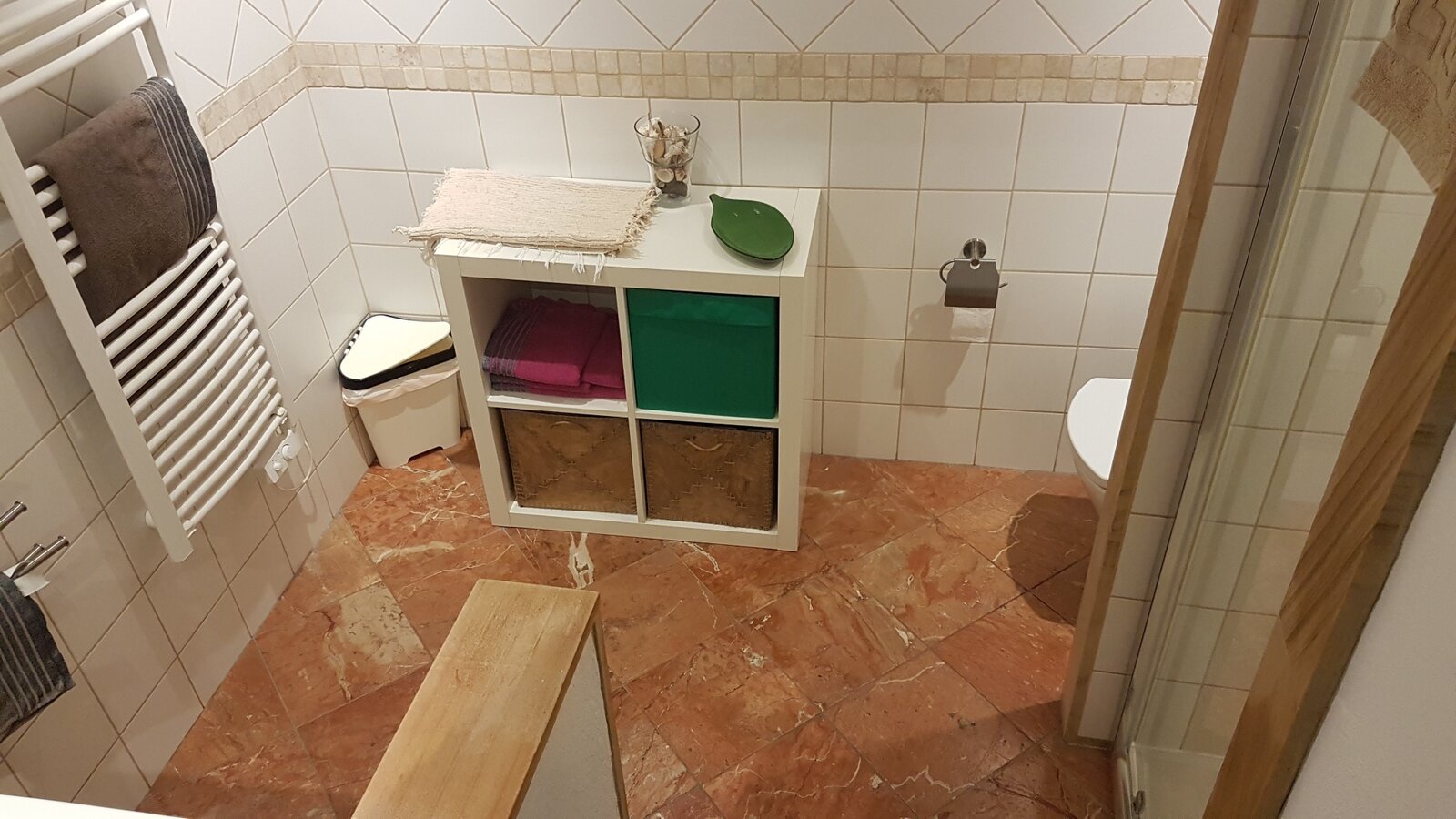 The second bathroom, with a heated towel rail and terracotta floor tiles