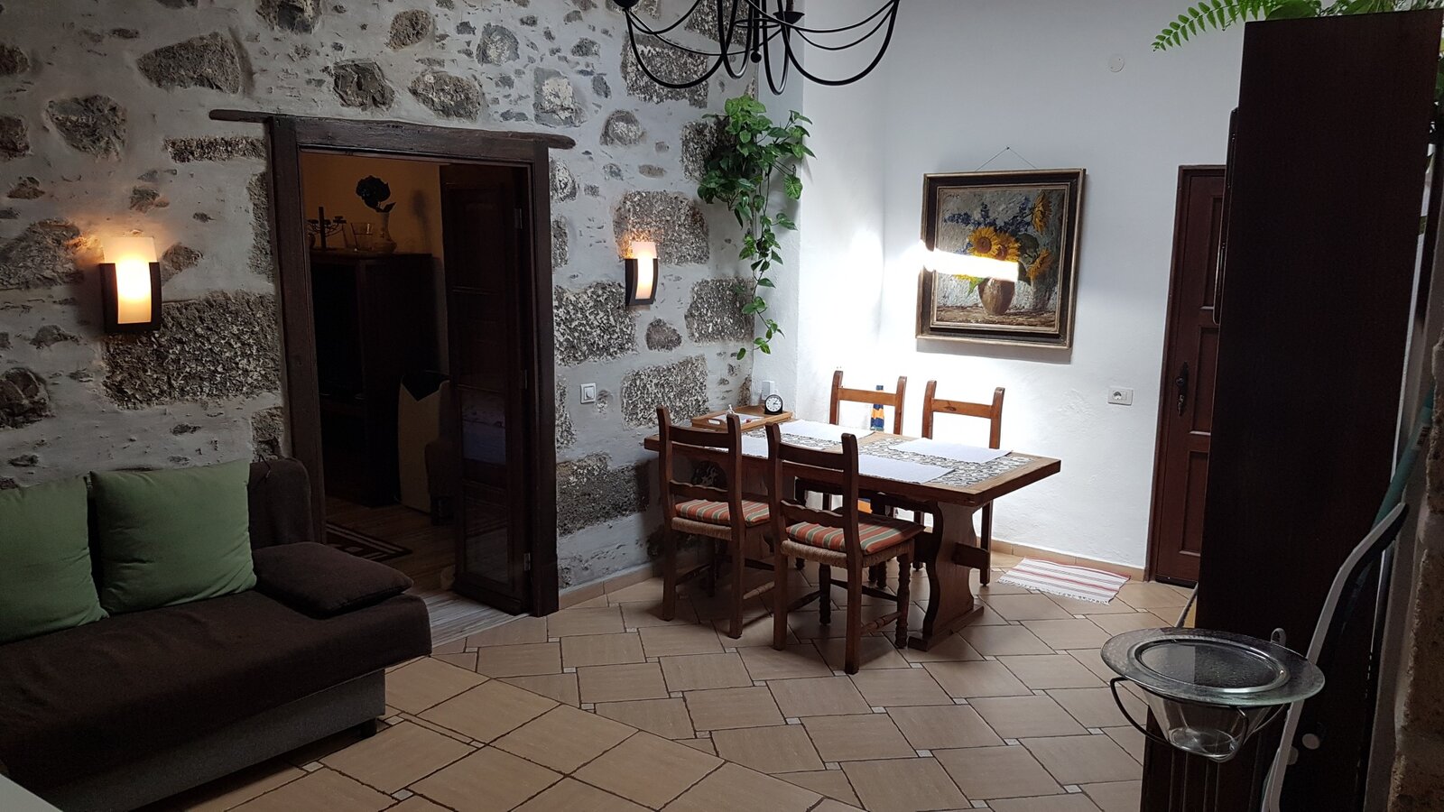 The living and dining room of the guest wing, with a sofa bed and a table for four