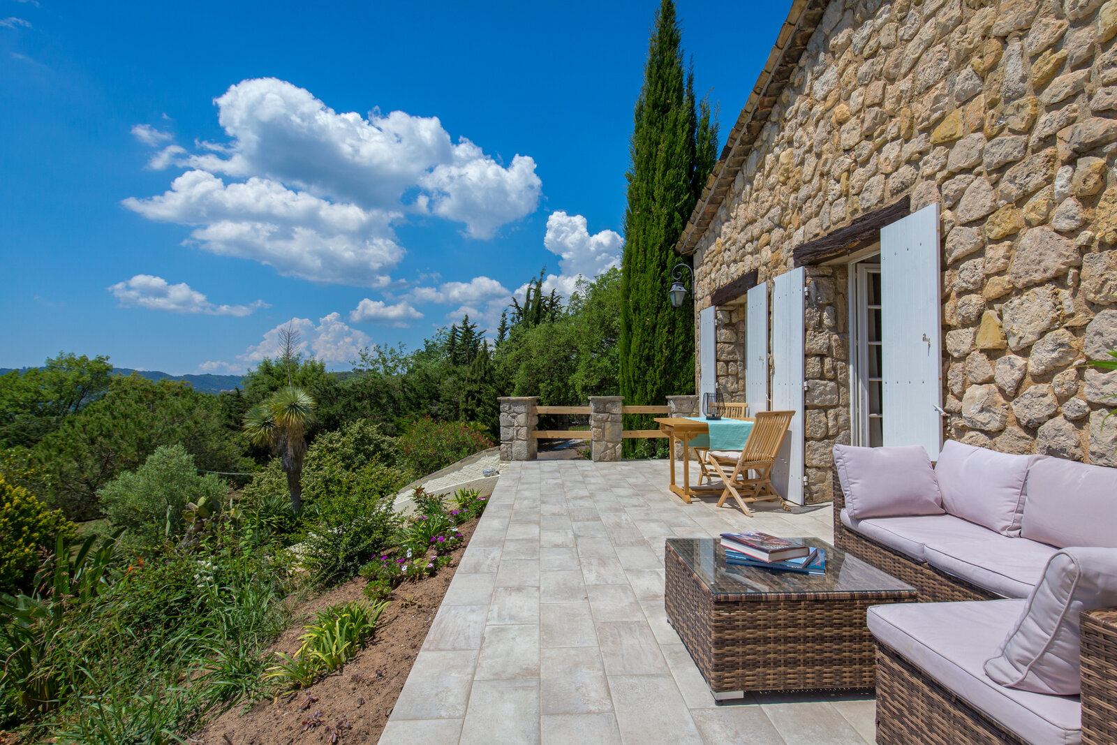 A terrace with seating, overlooking the hills.