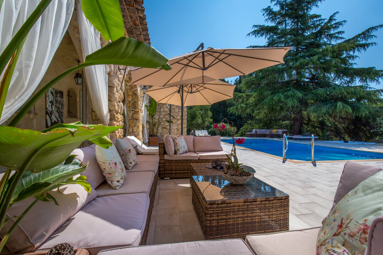 A shaded lounge corner beside the pool.