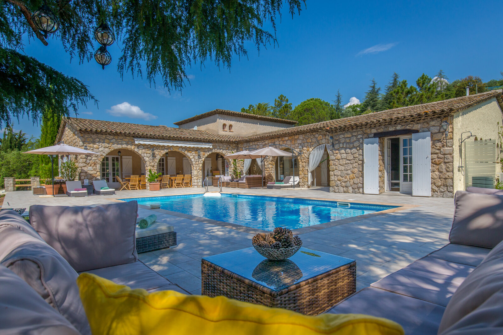 The pool terrace and stone farmhouse, seen from the lounge area.