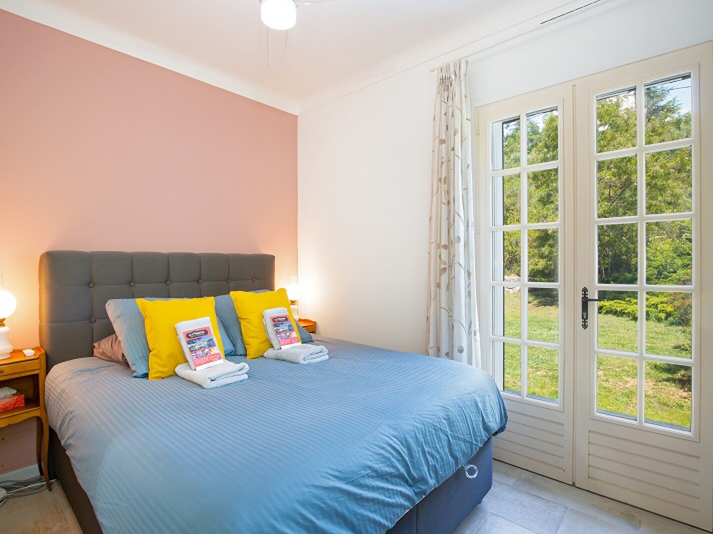 A bedroom in the Bardot room, opening onto the garden.