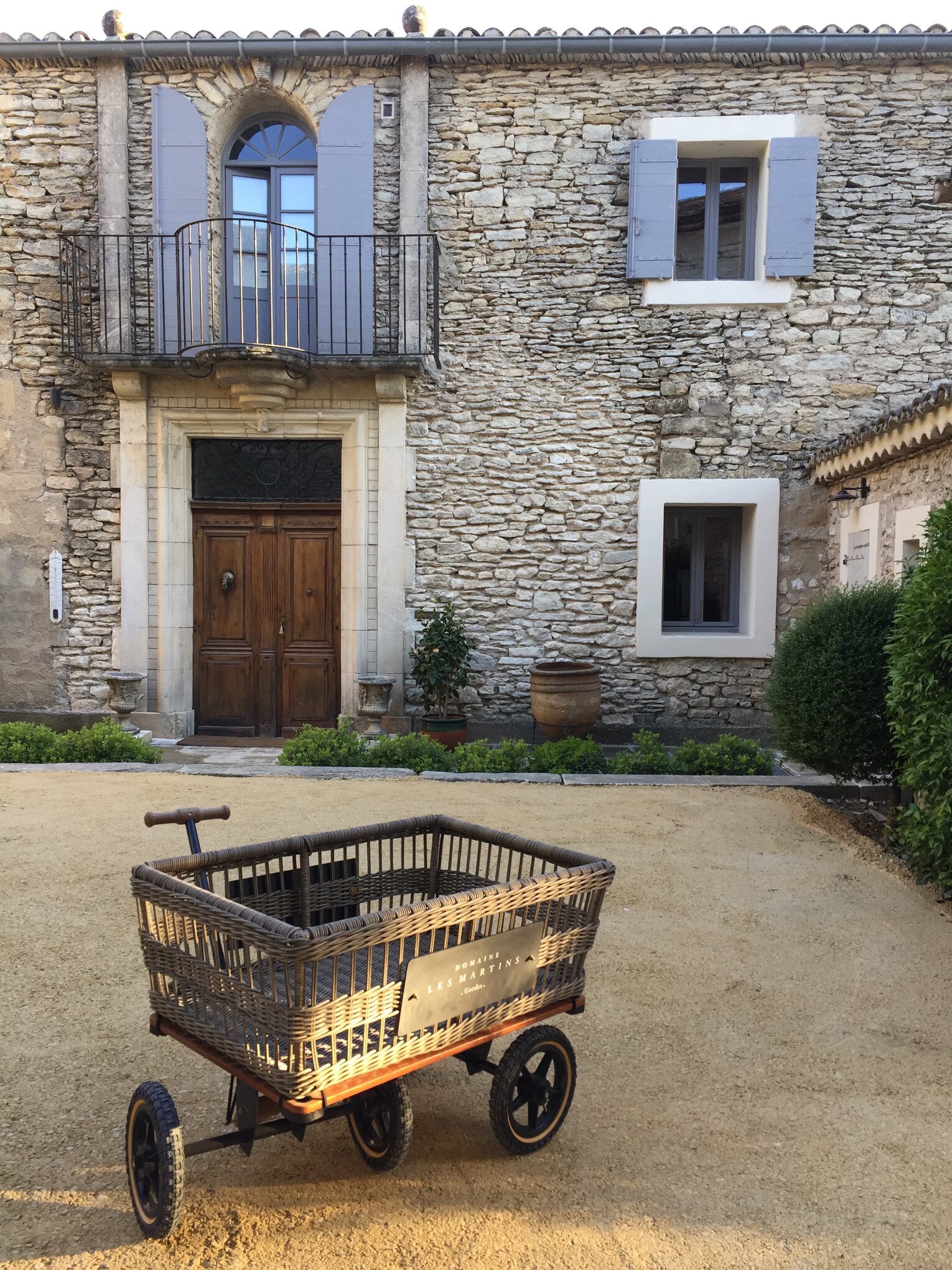 The main entrance, with a wicker luggage cart bearing the house name.