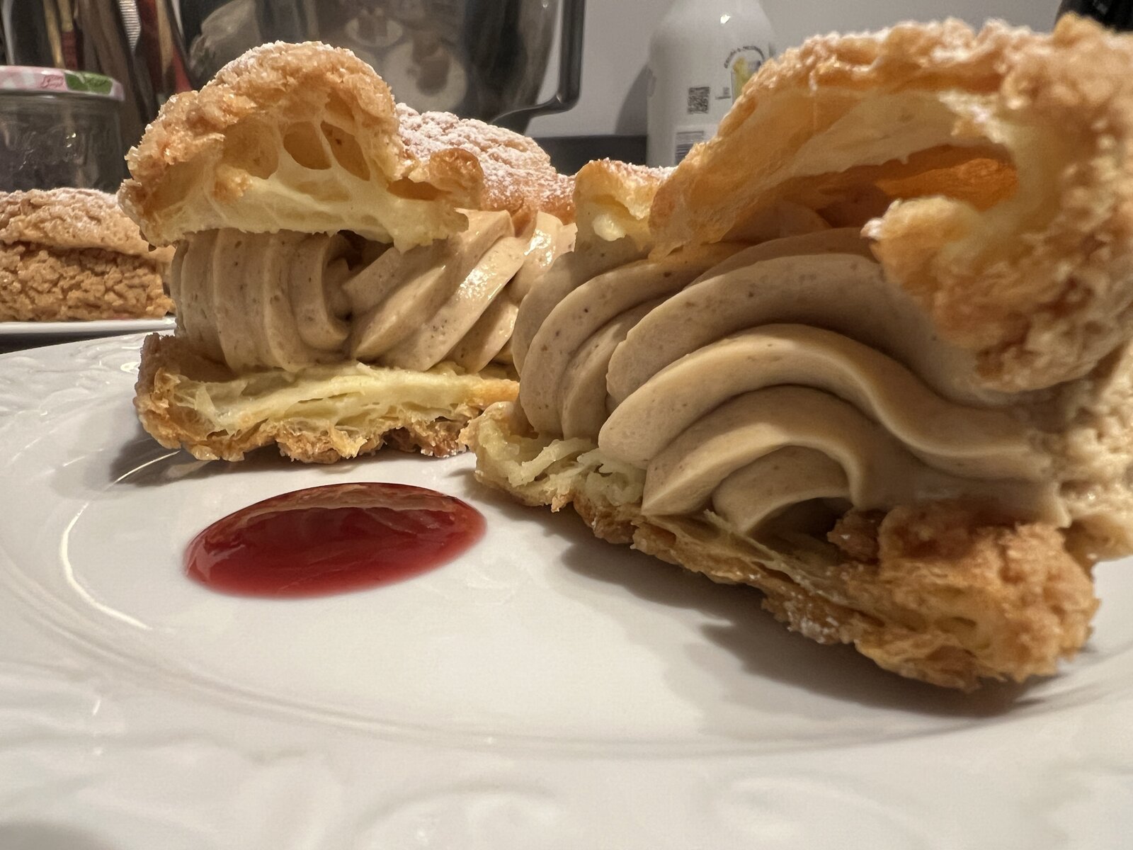 A choux pastry filled with coffee cream, cut open.