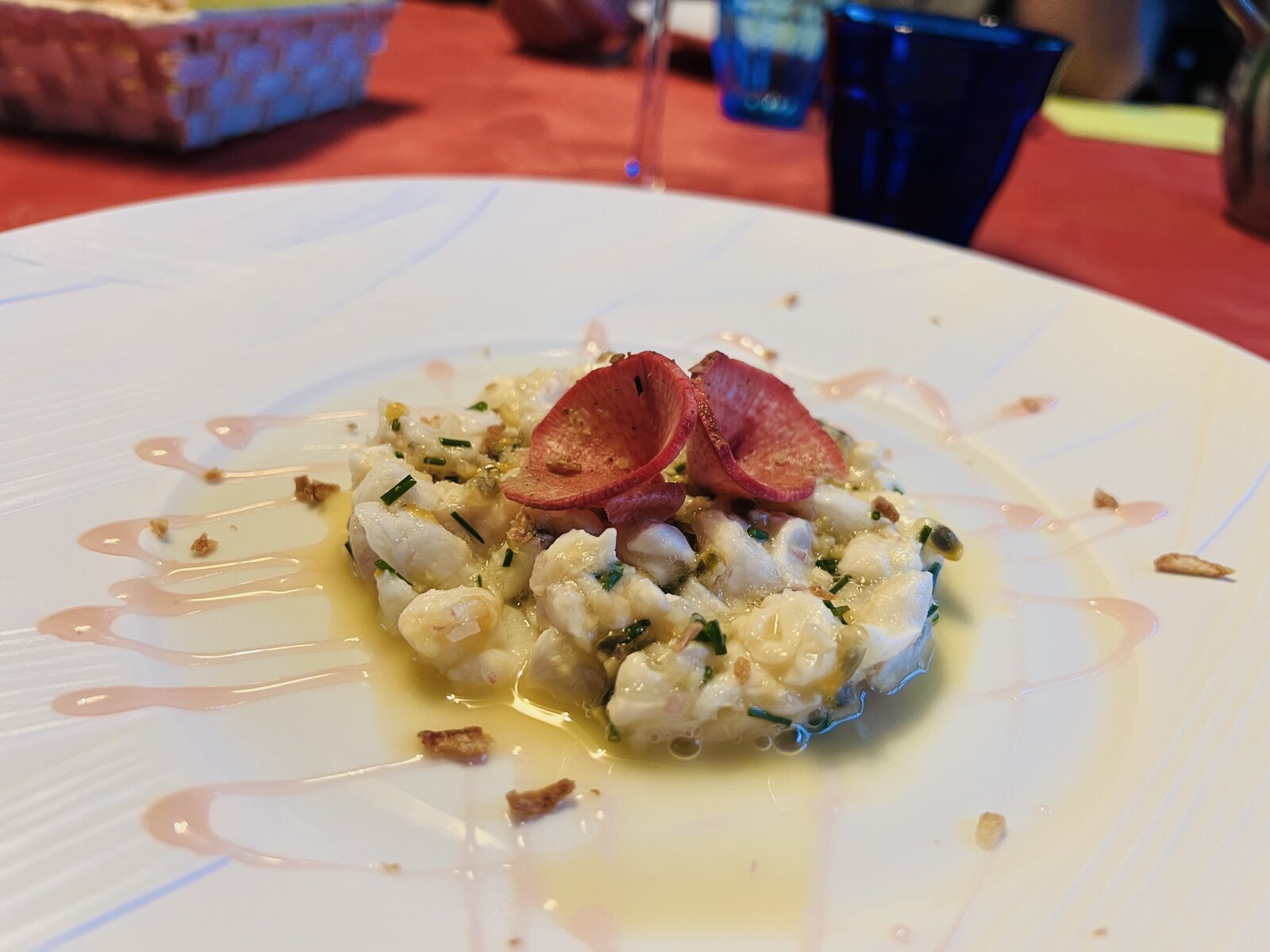 A seafood tartare garnished with radish.