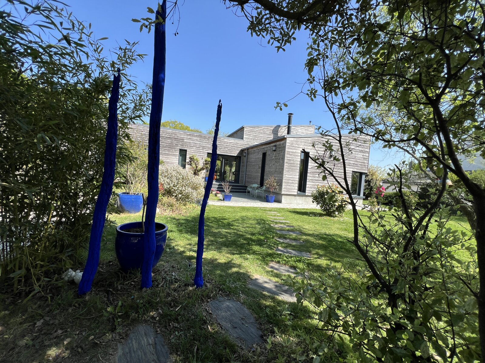 The guesthouse and garden, with blue-glazed pots and painted branches.