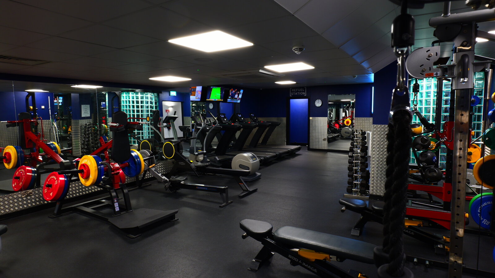 Fitness room with free weights, benches and treadmills.