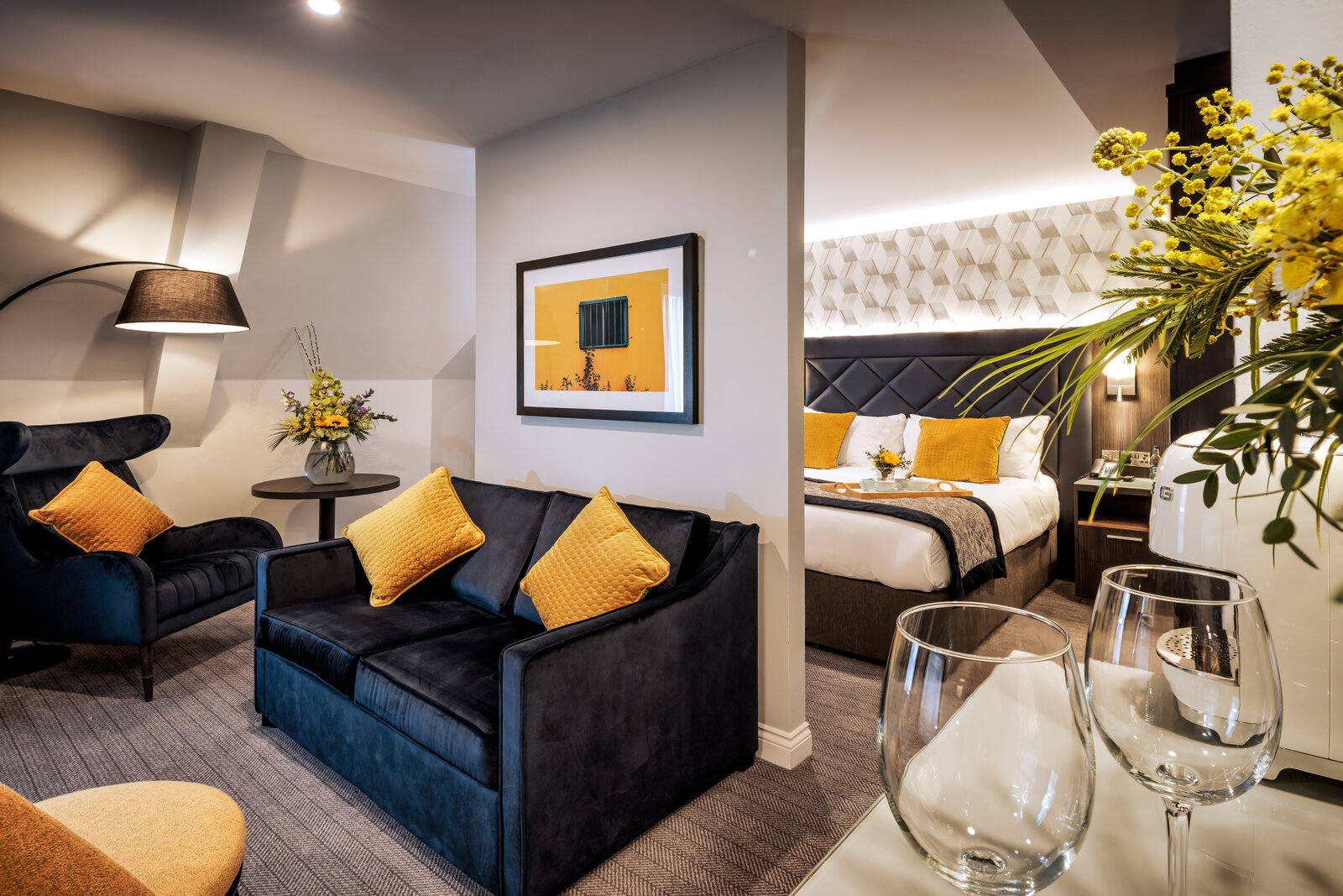 Junior suite with a separate seating area and the bed visible beyond.