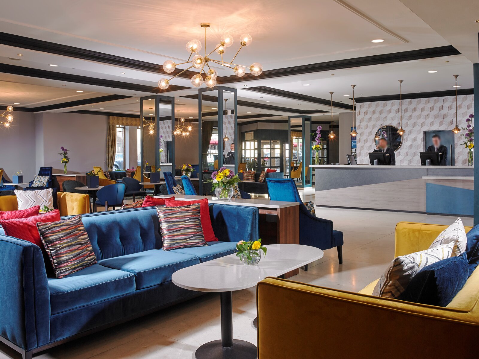 Reception desk and lobby seating area with blue sofas.
