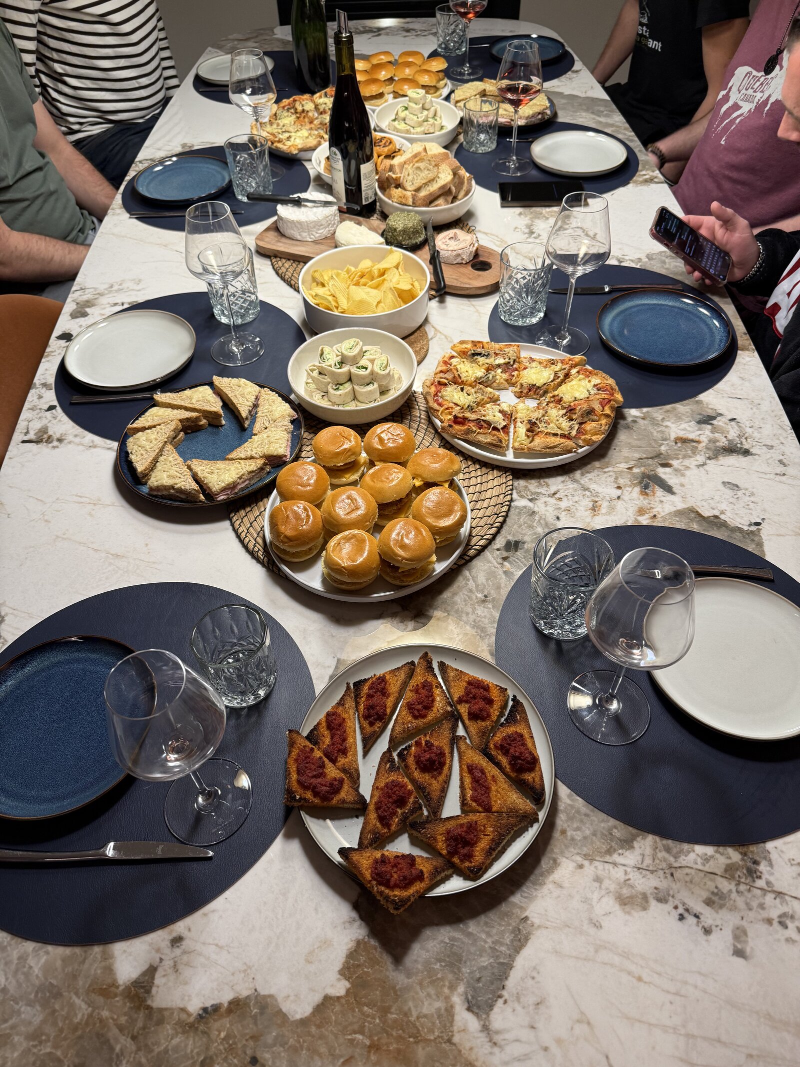 A shared dinner spread on the terrace table during a themed group stay.