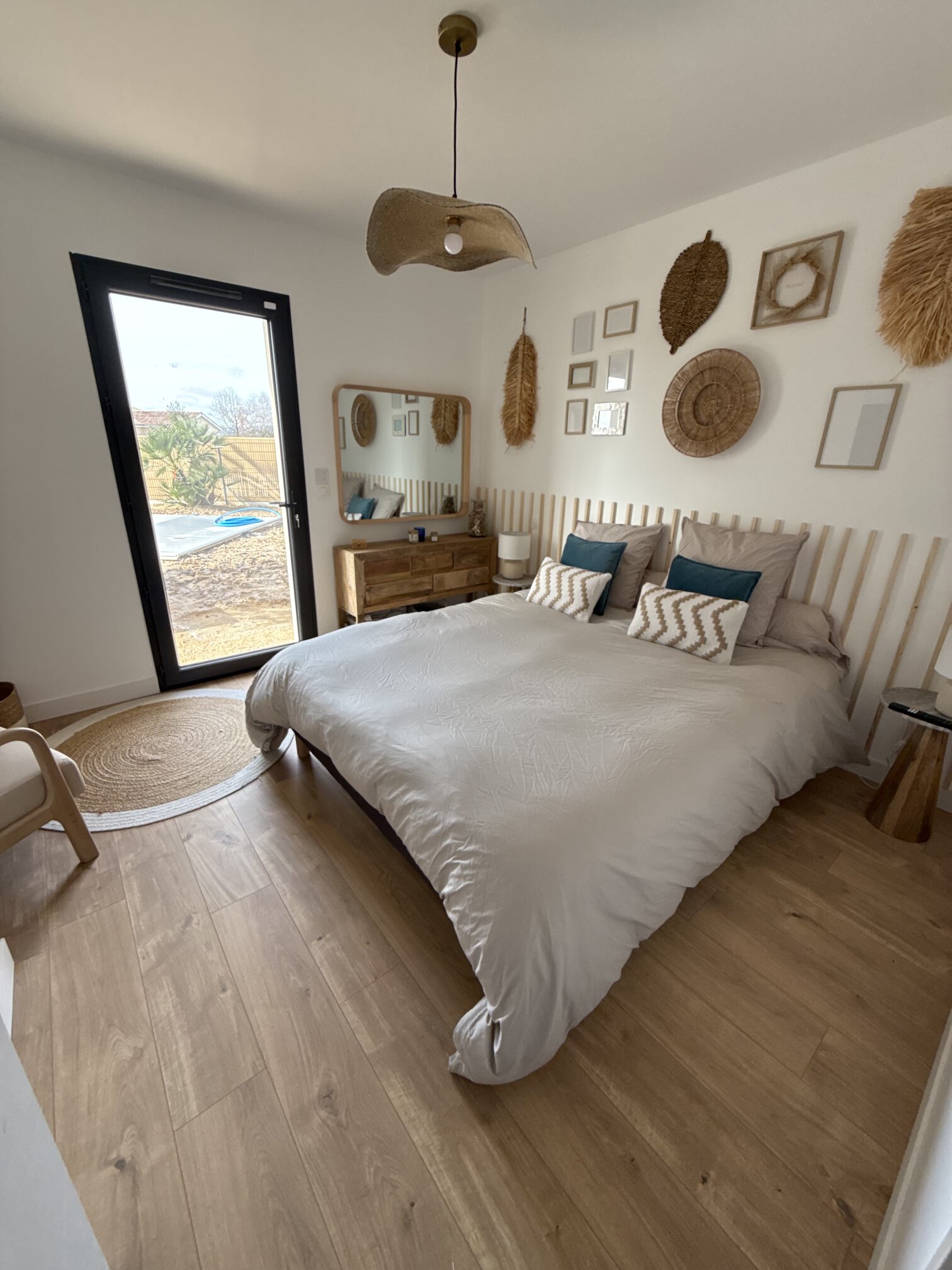 A boho-styled guest room opening straight onto the pool terrace.