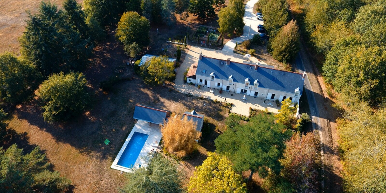 An aerial view of La Blinerie, showing the main house, the pool and the surrounding grounds.