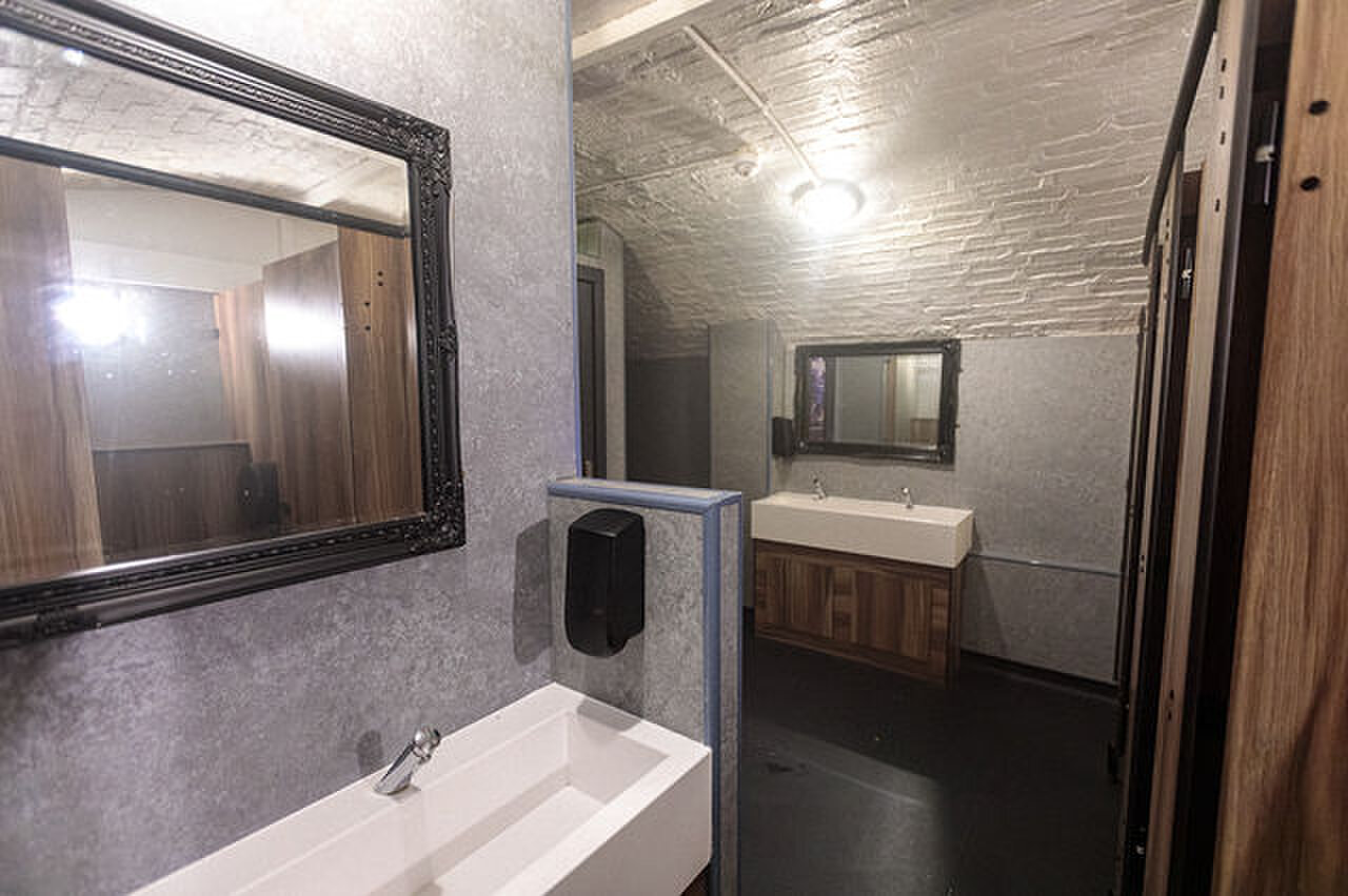 Basins and black-framed mirrors in the toilets.