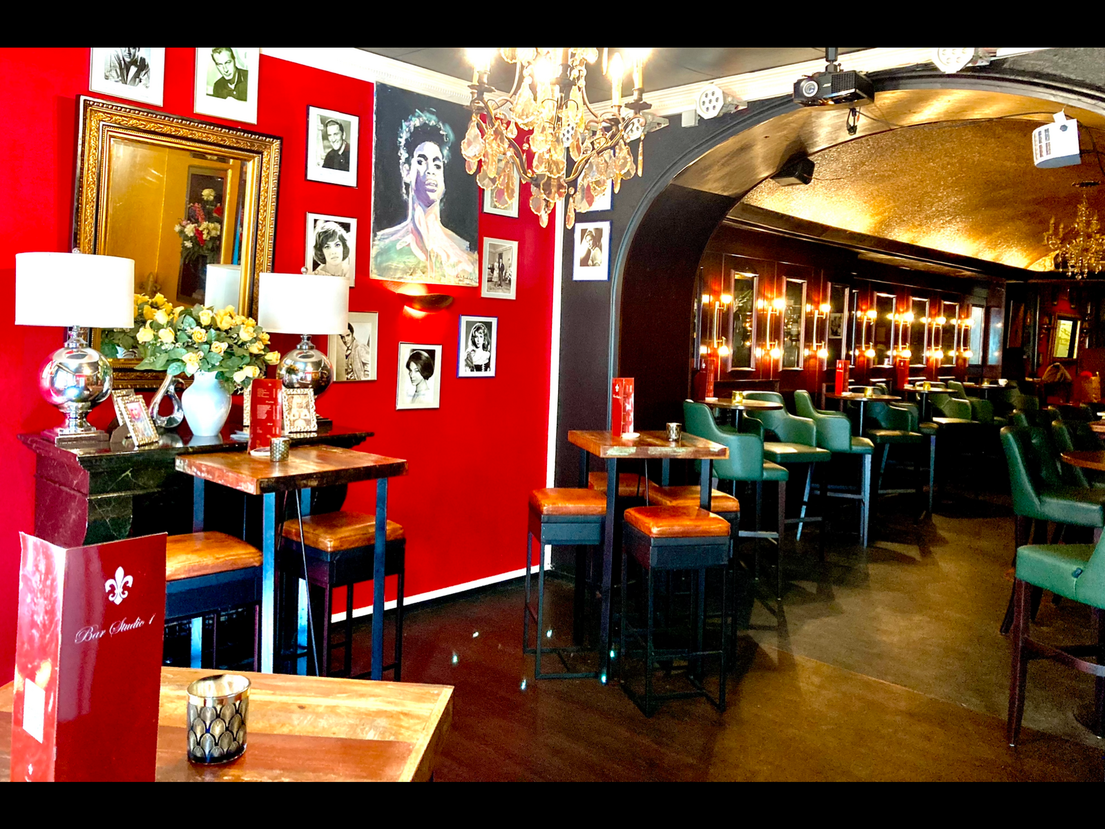 The red lounge with its portrait gallery, including a painted portrait of Prince, and the bar's own menu card.